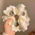 Blue bear bow and lace cloth hair ring with large intestine design on dark background
