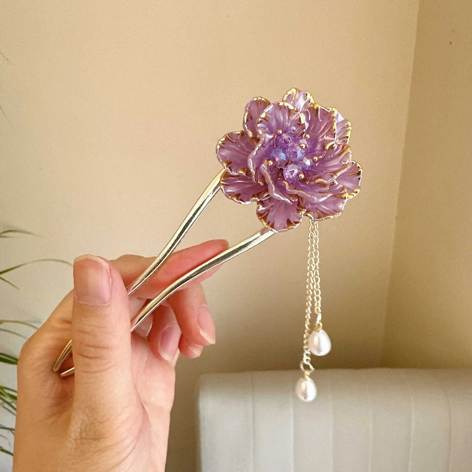 Close-up of a retro-style alloy U-shaped hairpin with a detailed purple peony flower and tassel design.