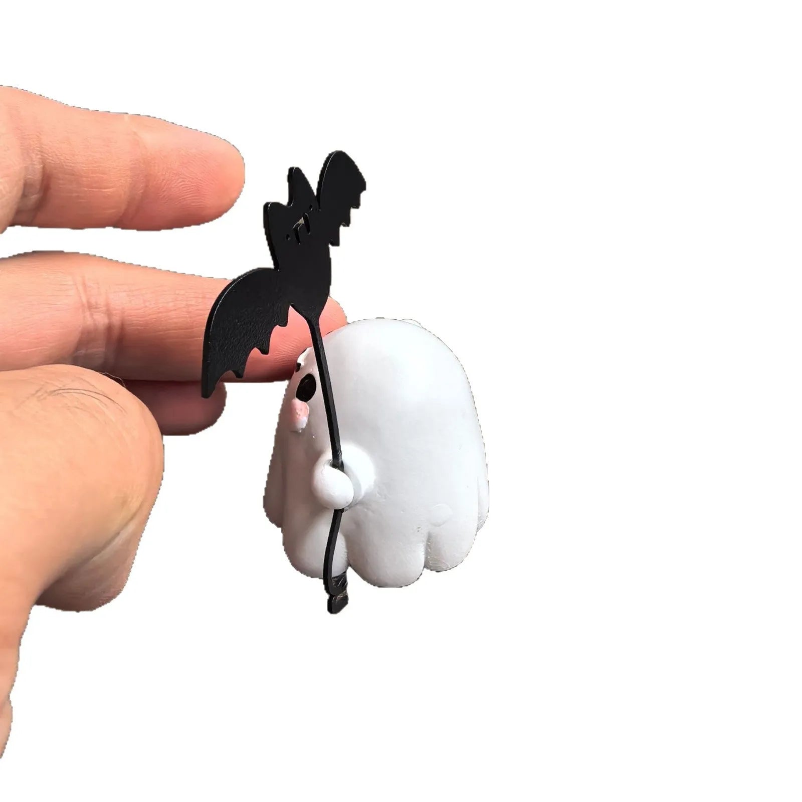 Small resin statue of a ghost walking a dog and holding a bat, a mini Halloween ornament.