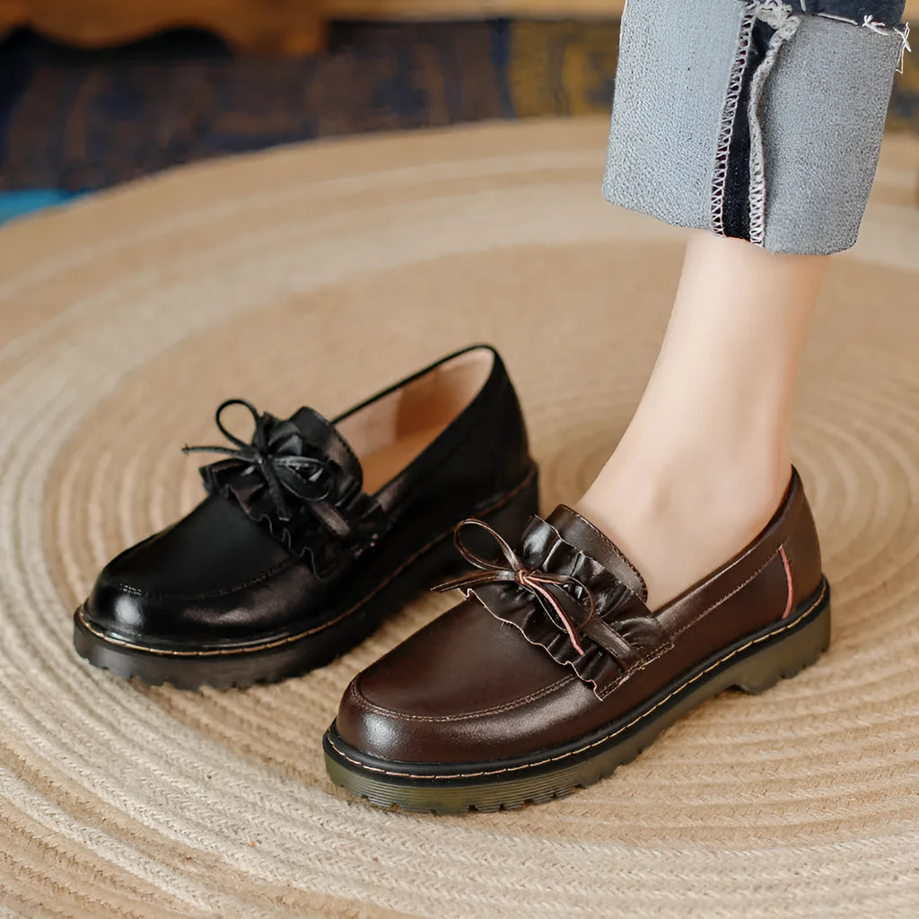 Women's black leather shoes with round toe and chunky flat heel on white background