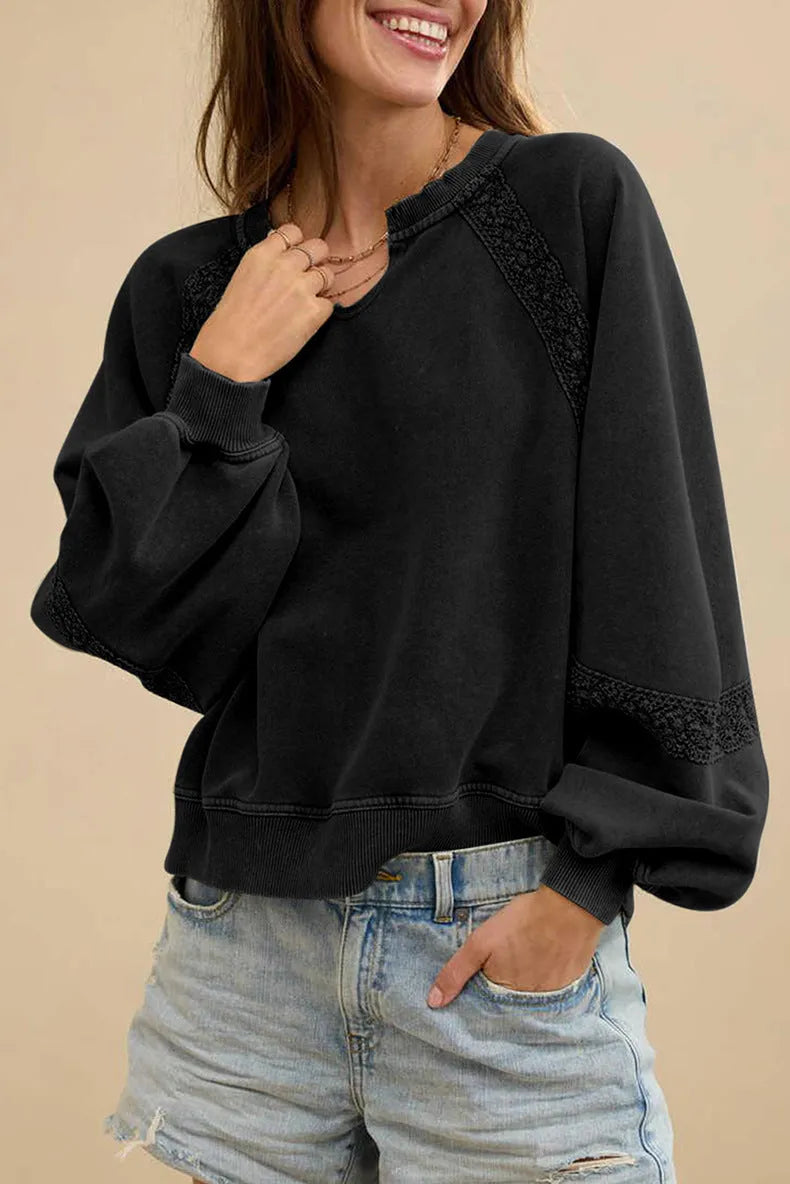 Women's solid colour sweater with a half-open collar featuring white stitching lace detail and long sleeves.