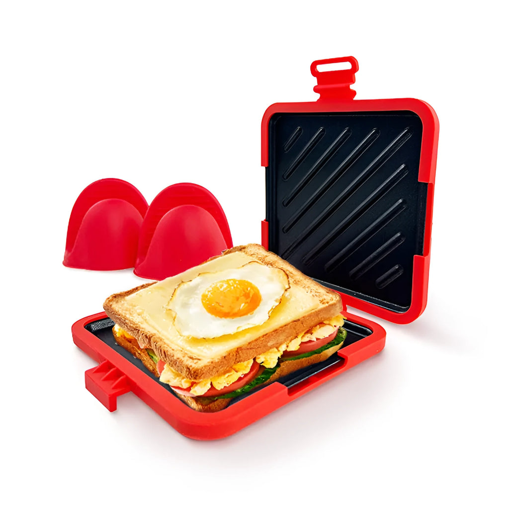 Red silicone baking tray and oven gloves set on a kitchen counter.