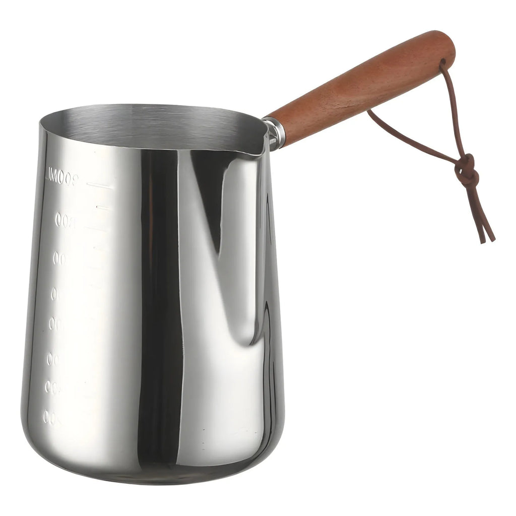 Stainless steel latte art milk cup with wooden handle and visible internal measurement scale.