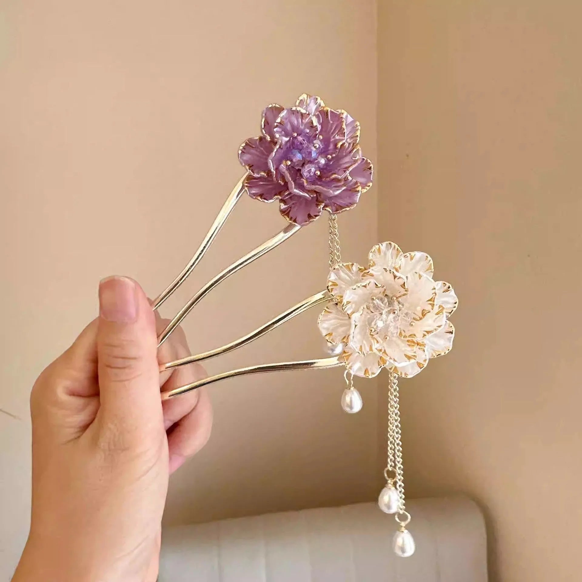 Close-up of a retro-style alloy U-shaped hairpin with a detailed purple peony flower and tassel design.