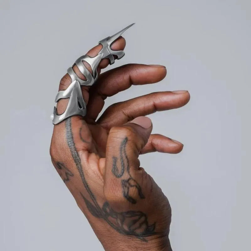Silver-coloured punk armour finger stall ring made from alloy.
