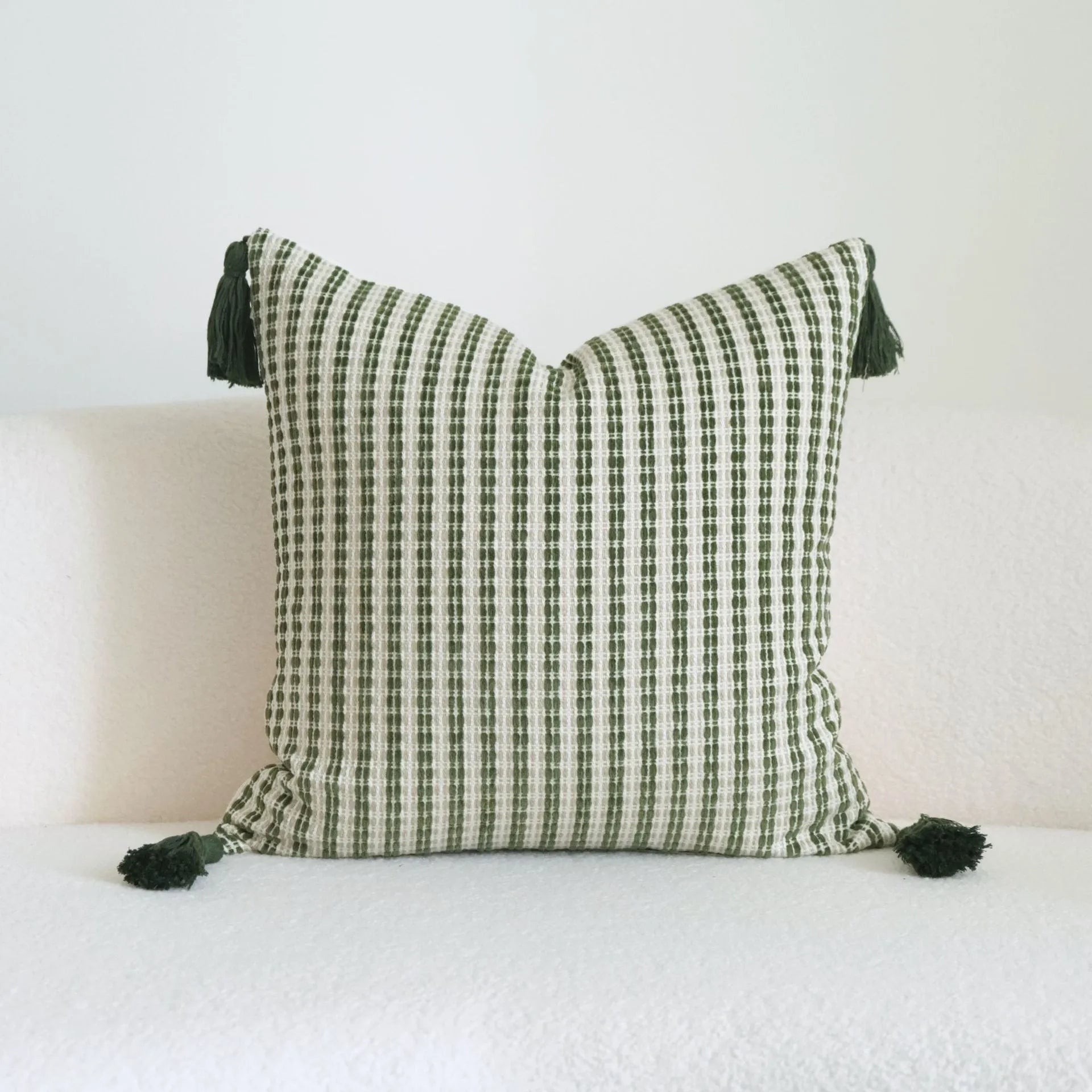 Green botanical pattern hotel sample pillow with tassel detail on linen cotton cover