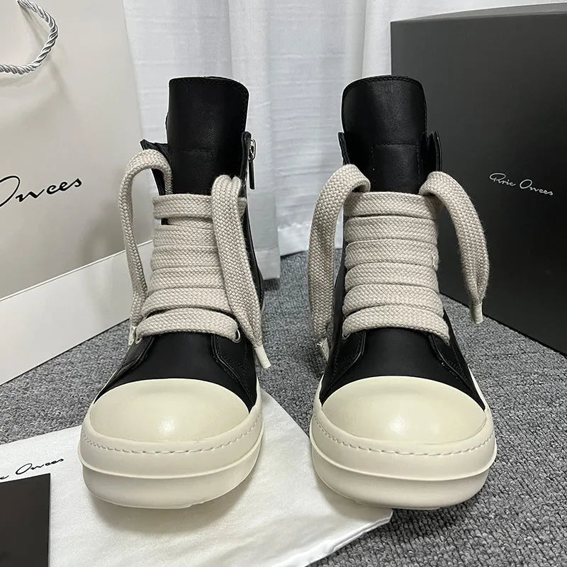 Black high-top leather sneakers with side zipper and platform sole on a white background