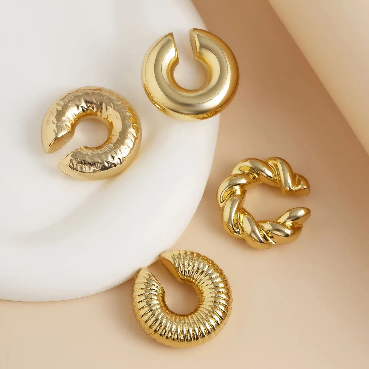Set of four geometric clip-on earrings for women in gold and silver colours