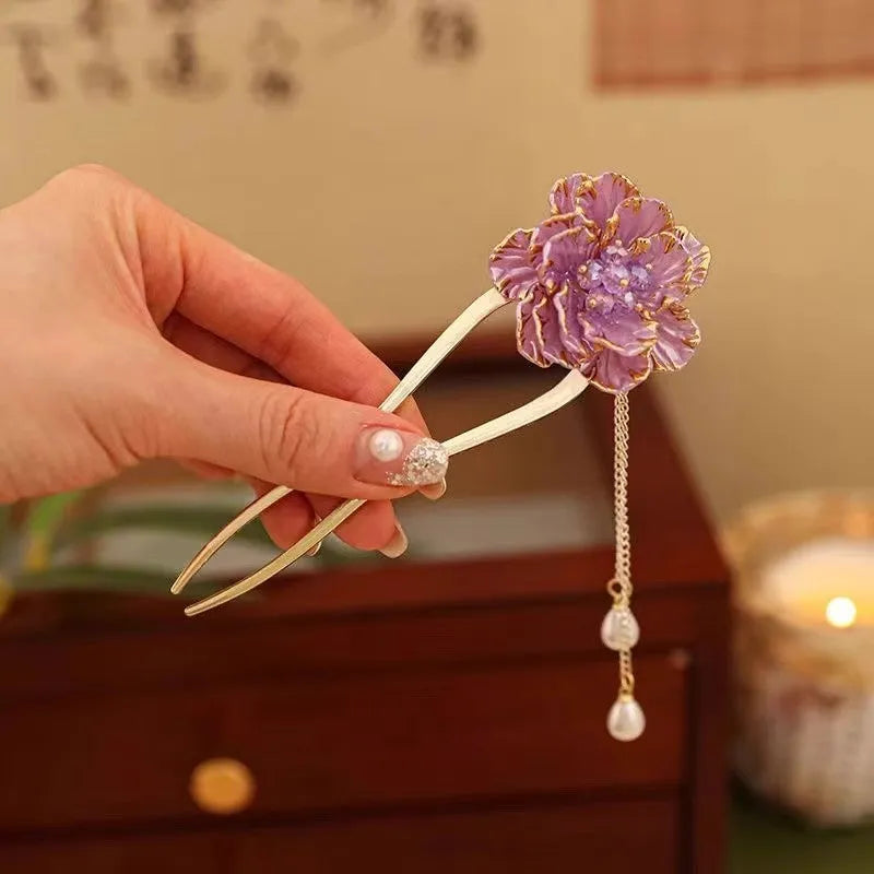 Close-up of a retro-style alloy U-shaped hairpin with a detailed purple peony flower and tassel design.