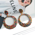 Large round pendant earrings with cartoon design and diamante accents on alloy metal
