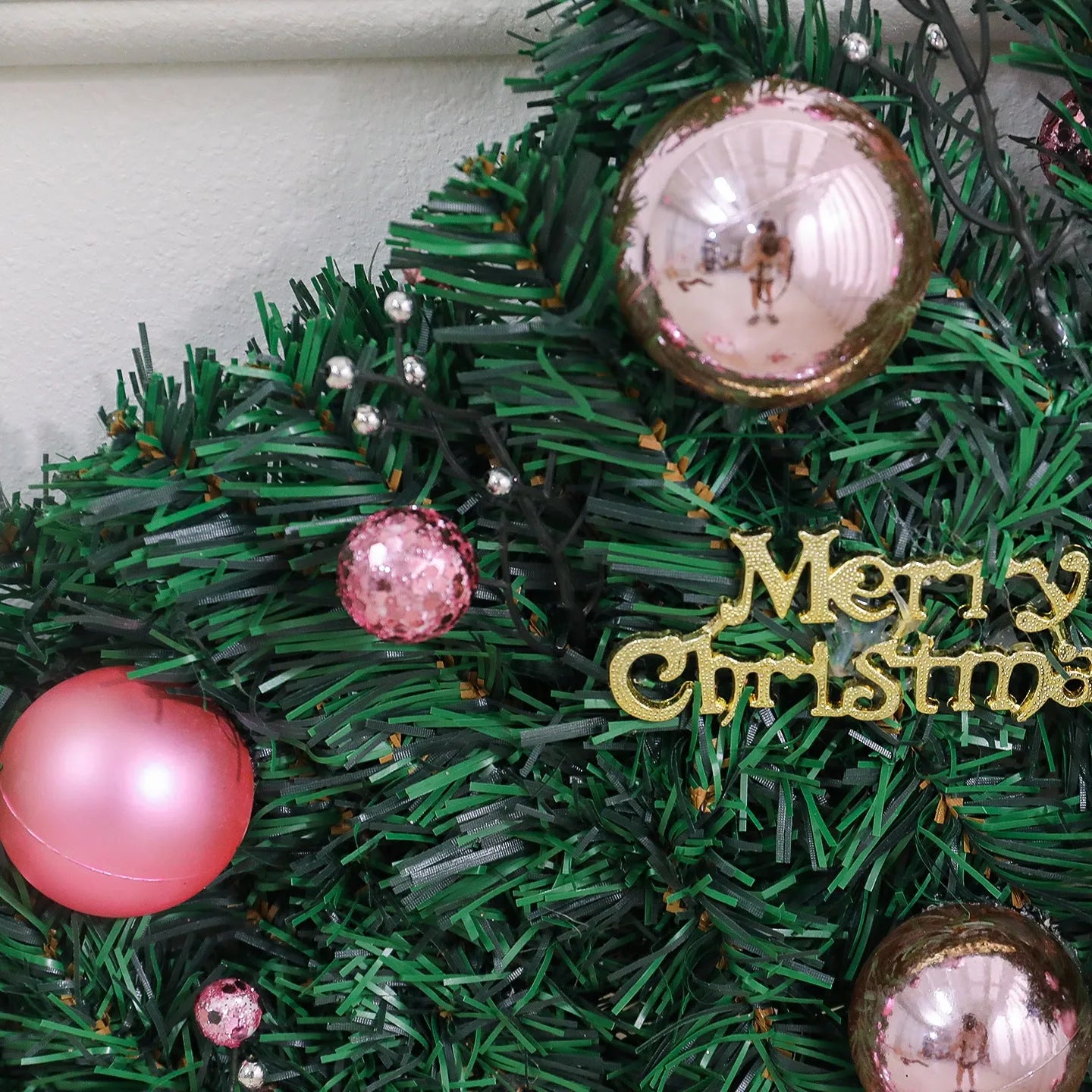 2.7 metre pink artificial rattan Christmas vine decoration with small fruit accents and LED lights