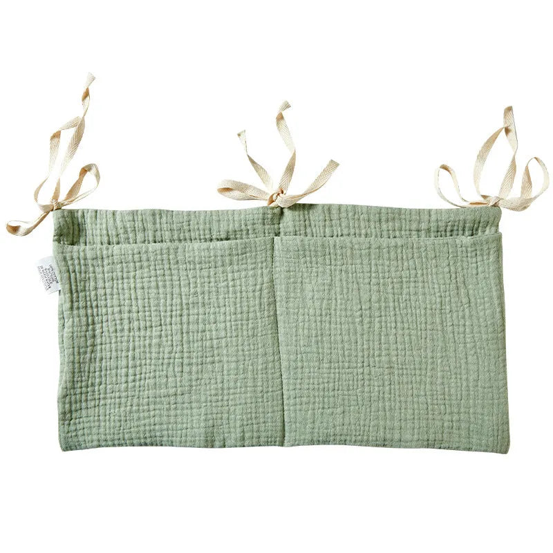 Cotton double layer baby bedside buggy bag in camel colour with tie straps attached to a pram handle