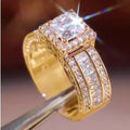 Geometric silver-toned women's fashion ring in gold or white colour on a grey background.