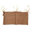 Cotton double layer baby bedside buggy bag in camel colour with tie straps attached to a pram handle