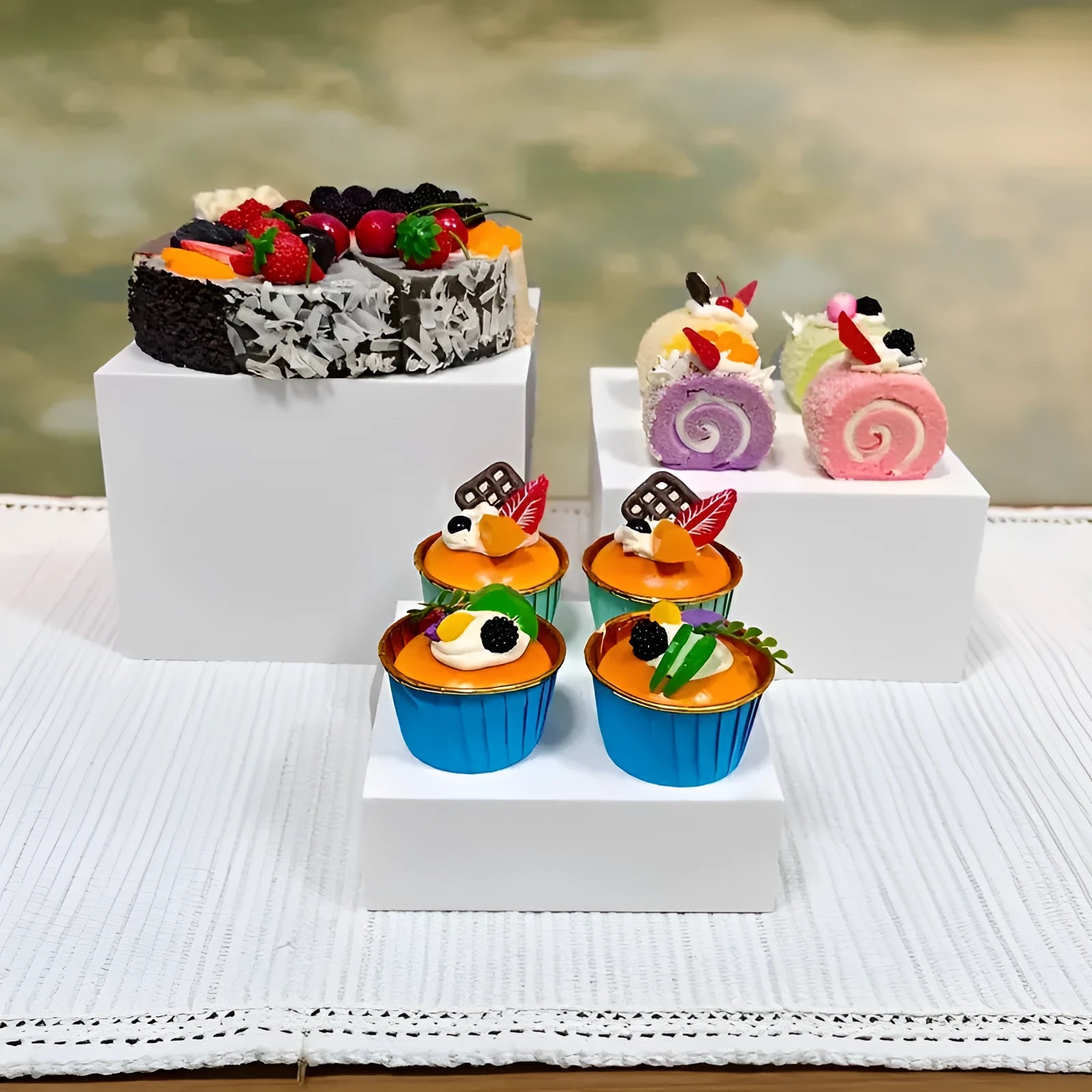 Six identical white plastic cube dessert display stands arranged together.