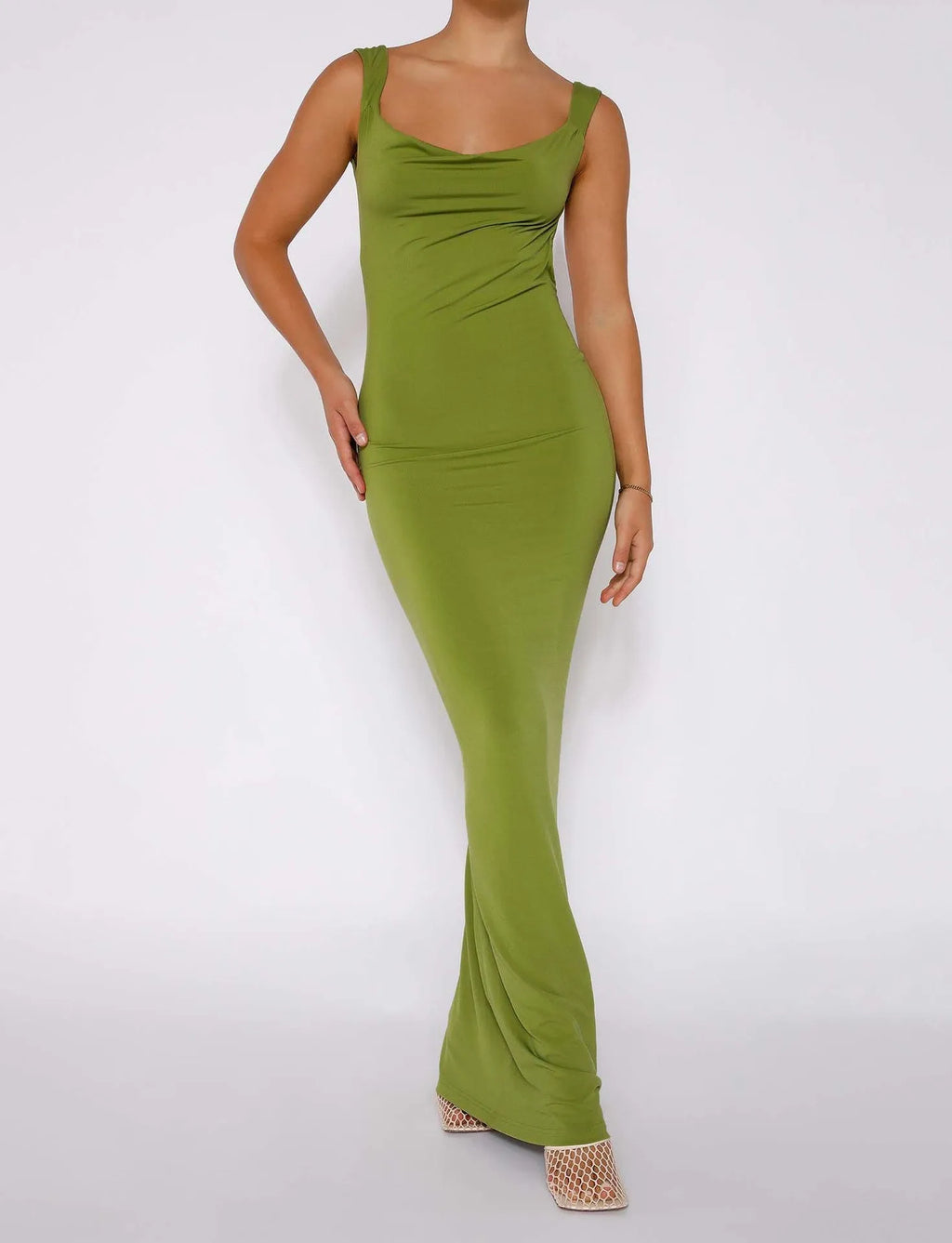Backless slim fit milk silk dress with spaghetti straps in champagne colour, showing long hip skirt silhouette
