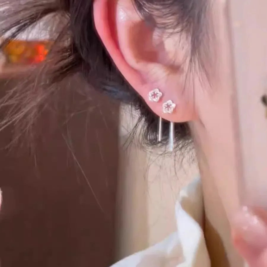 Silver flower hanging earrings with hollow petal design and stud backings