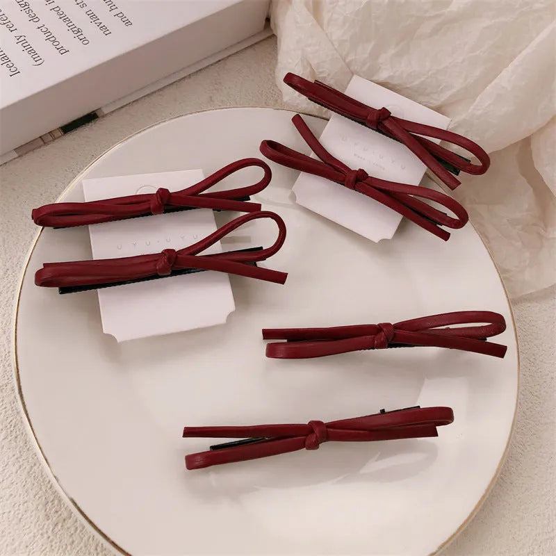 Wine red leather bow hair barrette showing handmade bow design detail