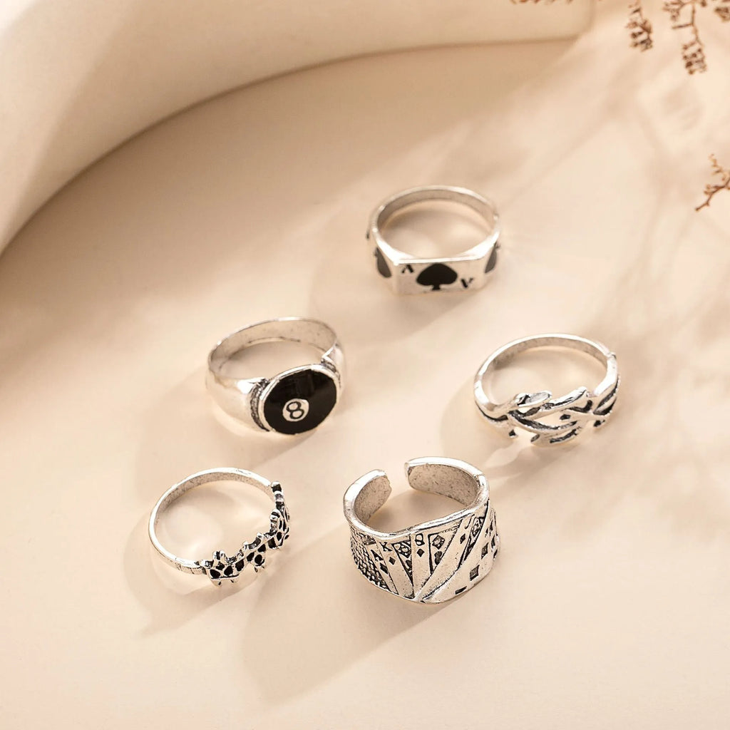 Black alloy poker ring with a large spade design and adjustable band.