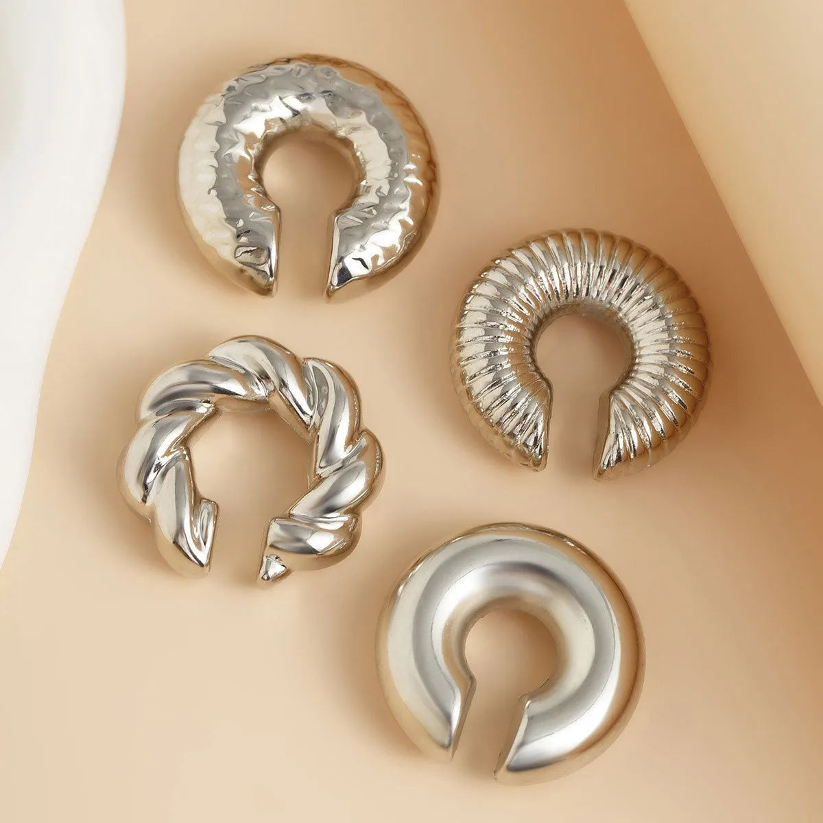 Set of four geometric clip-on earrings for women in gold and silver colours