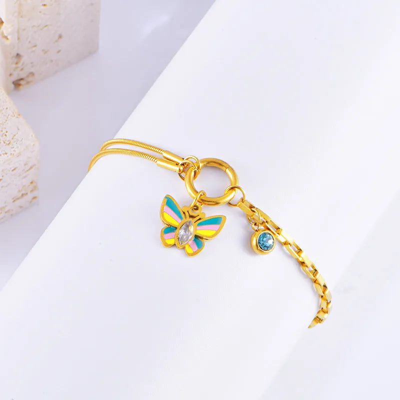 Gold coloured titanium steel necklace and bracelet set with colourful epoxy butterfly pendant