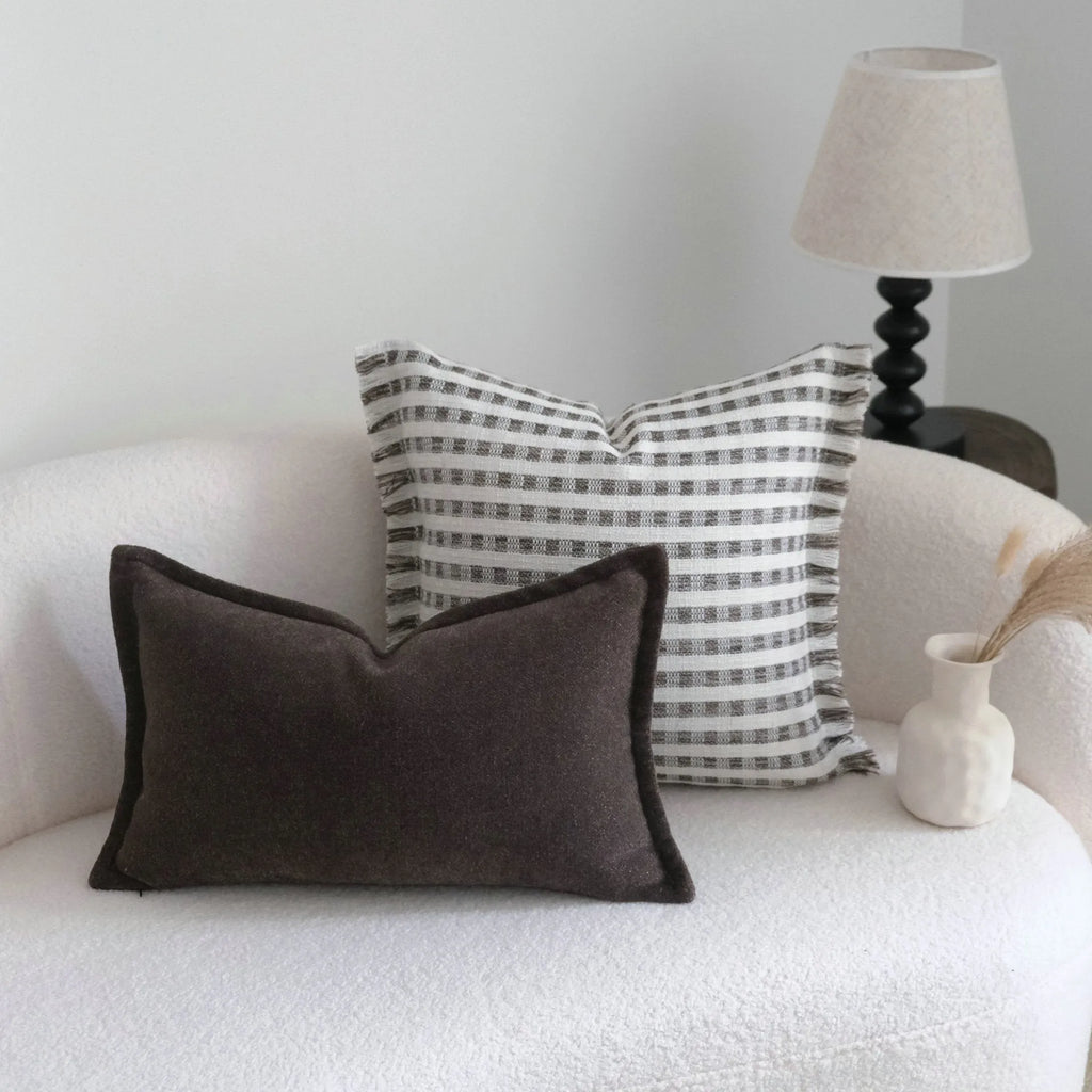 Coffee brown striped mid-century sofa cushion in Chinese classical style on a grey sofa.