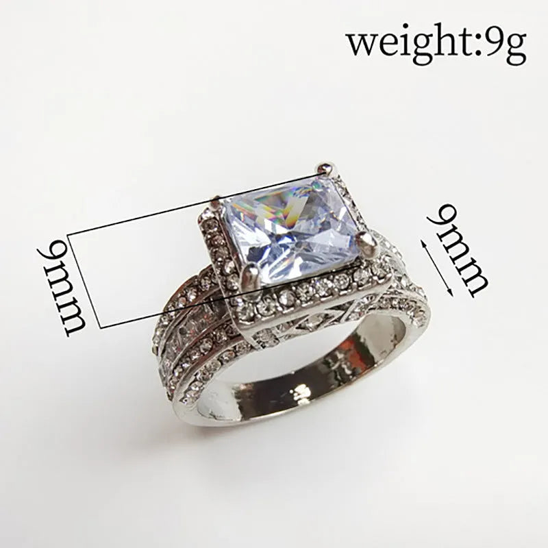 Geometric silver-toned women's fashion ring in gold or white colour on a grey background.