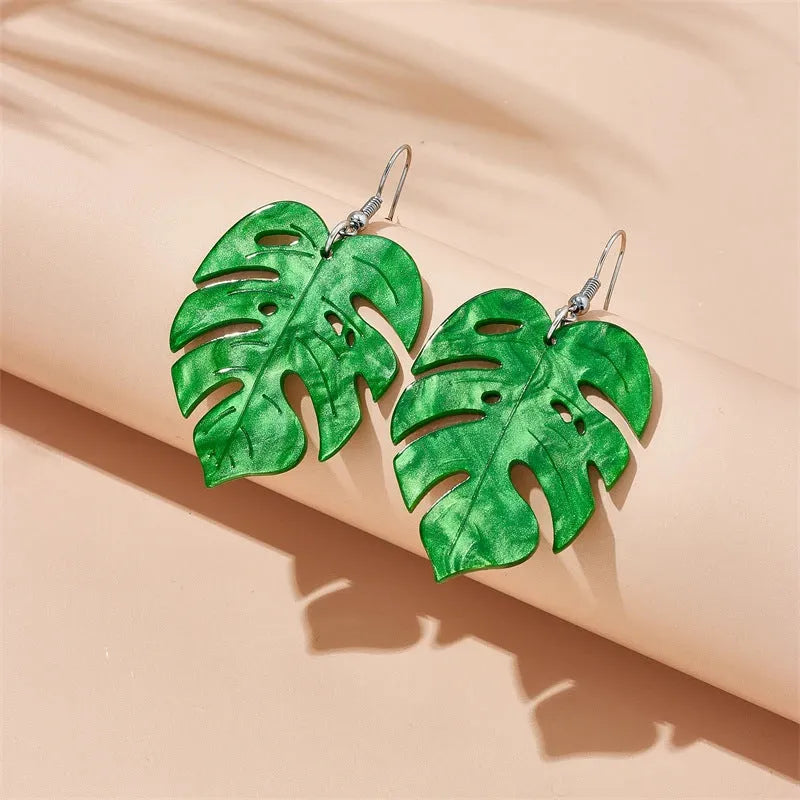 Drop shaped alloy and acrylic ear hook earrings with coconut summer design in multiple colours.