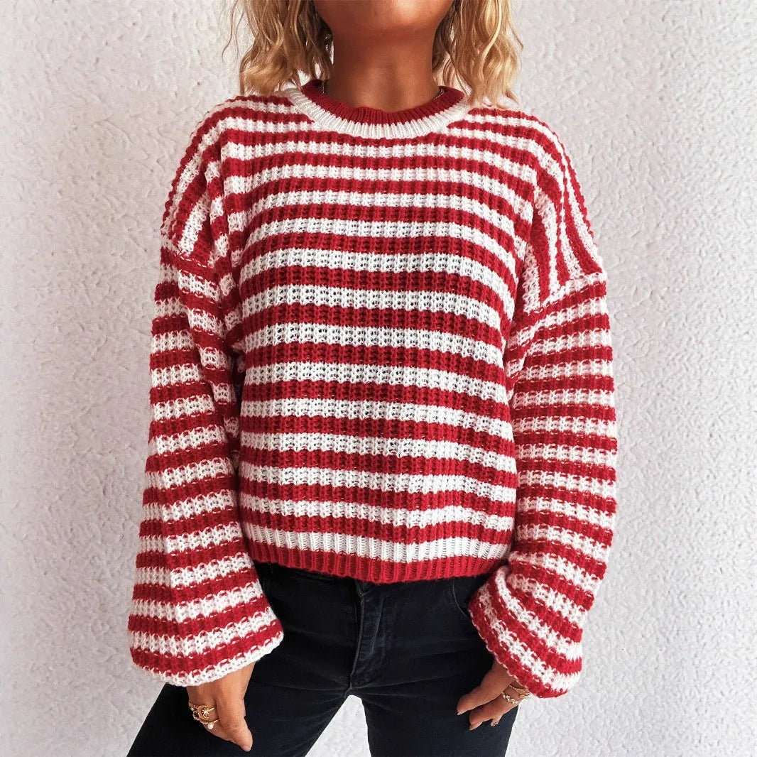 Woman wearing a vintage striped loose-fit pullover sweater in a khaki colour.