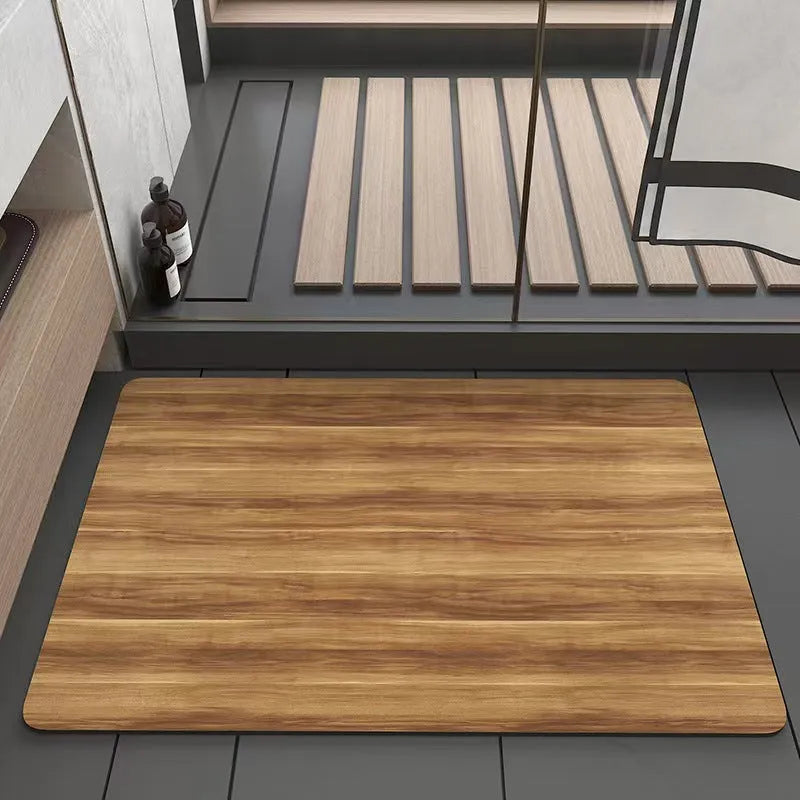 Square diatomite bathroom floor mat with wood grain geometric pattern in a bathroom setting.