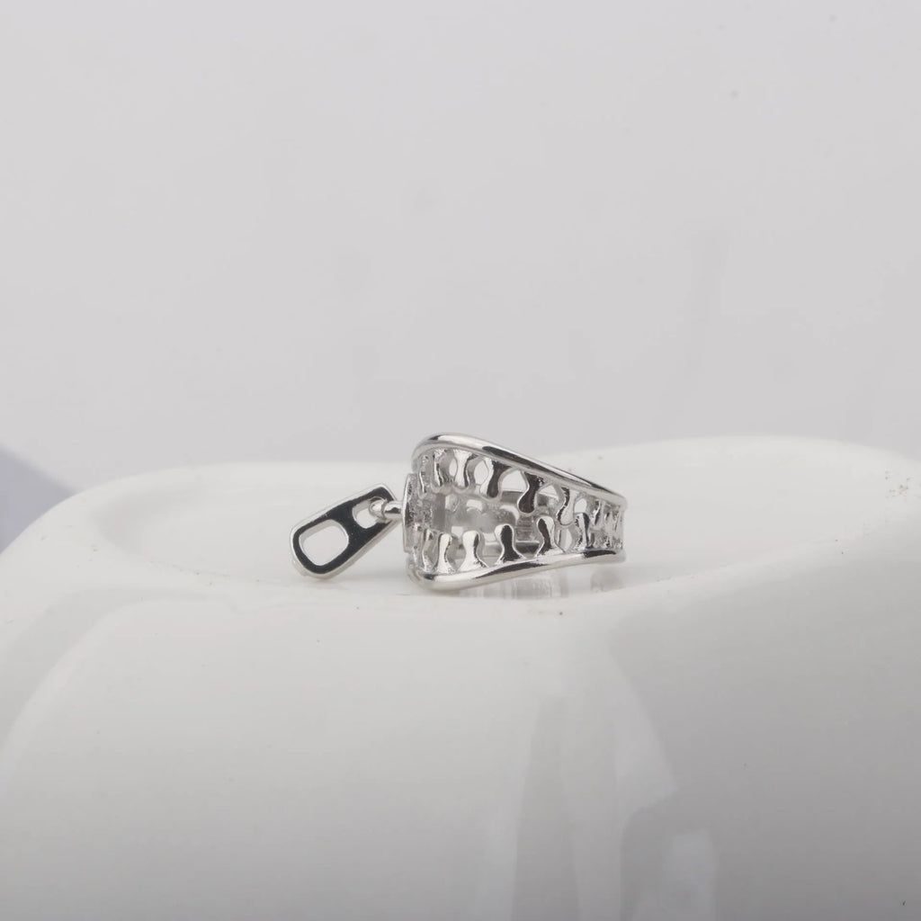A pair of simple geometric copper clip-on earrings with a linear design on a white background.