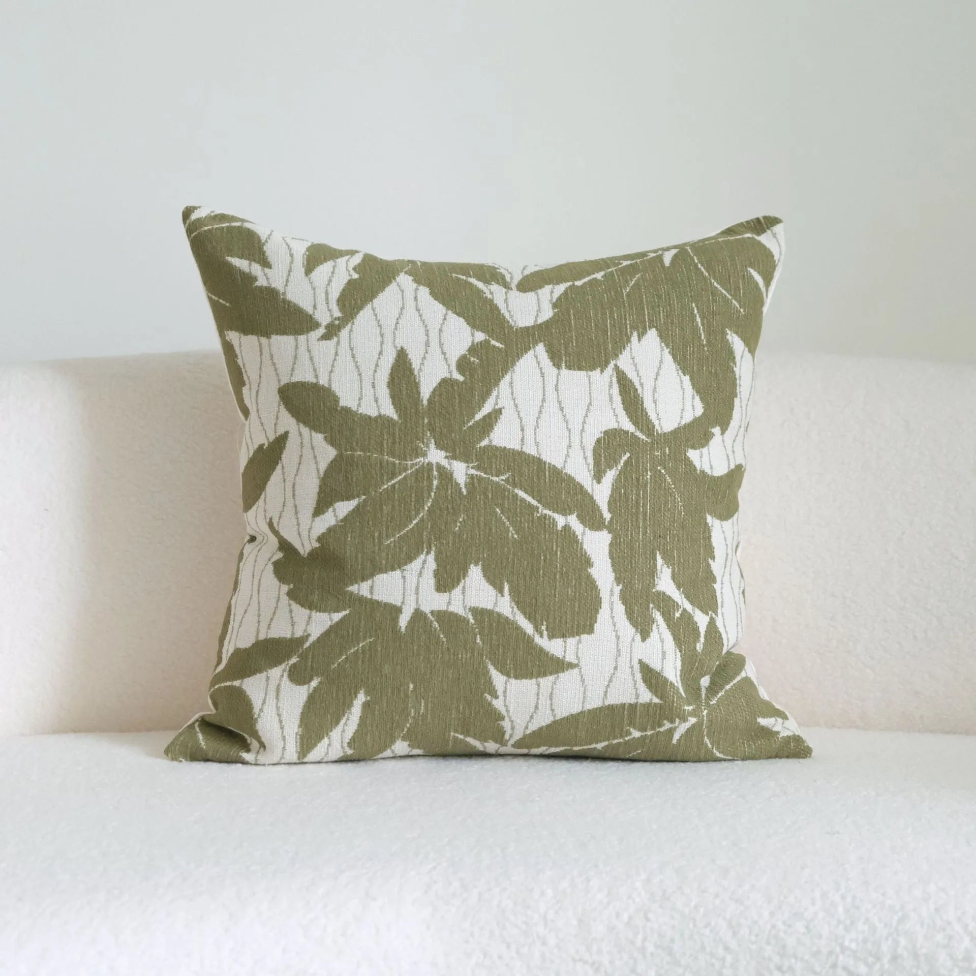 Green botanical pattern hotel sample pillow with tassel detail on linen cotton cover