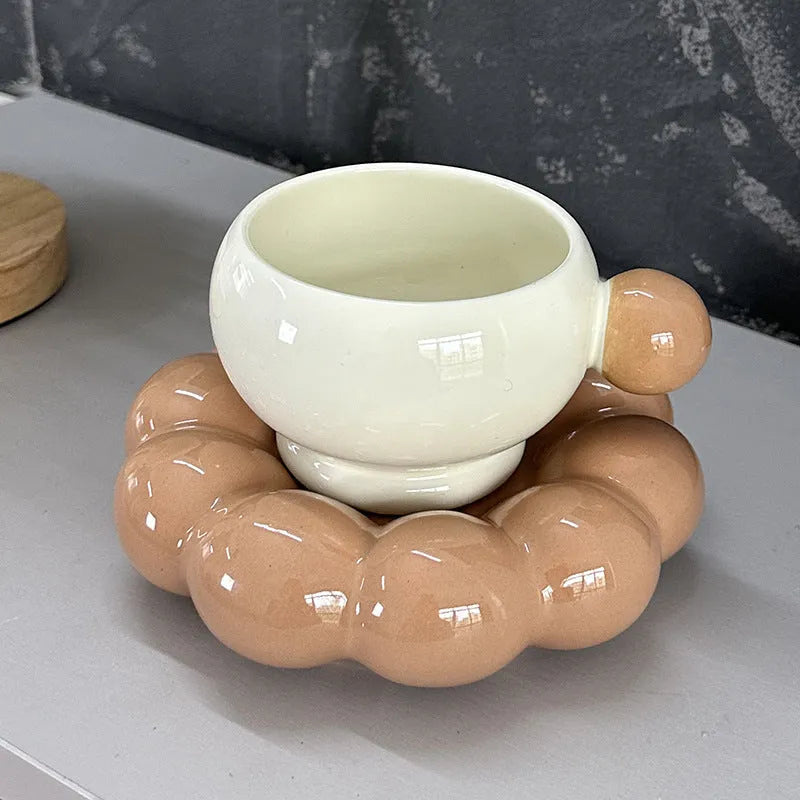 Ceramic coffee cup and saucer set in a simple solid colour, showing the 250ml cup resting on its matching dish.