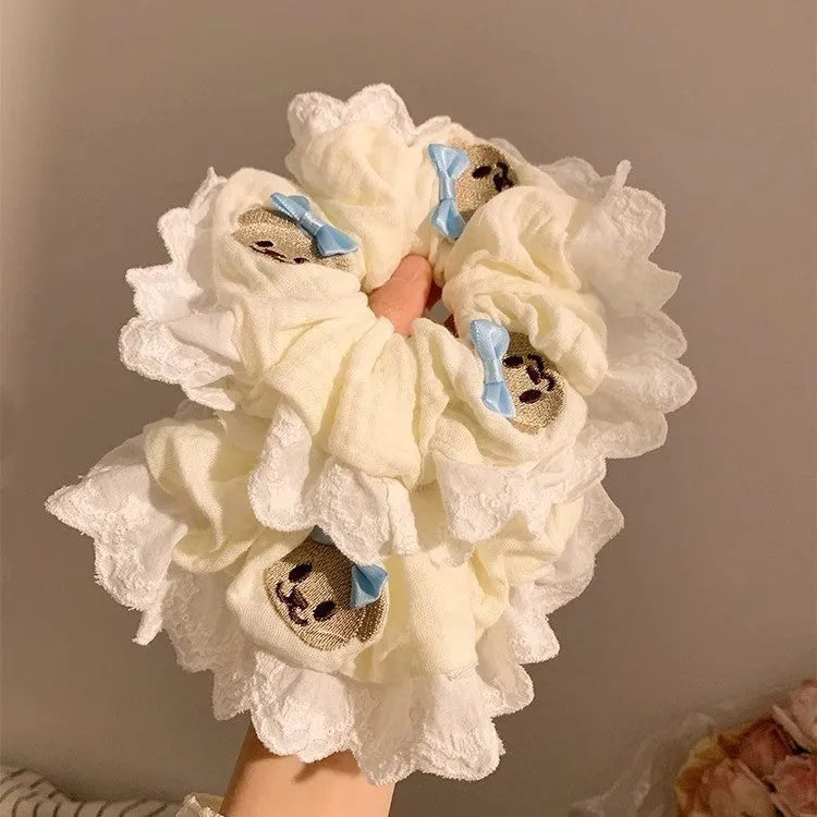 Blue bear bow and lace cloth hair ring with large intestine design on dark background