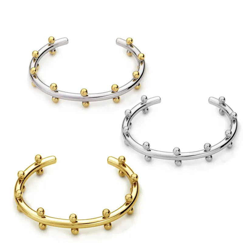 Stainless steel C-shaped bracelet with rivet-shaped bean beads and adjustable alloy chain in steel gold colour