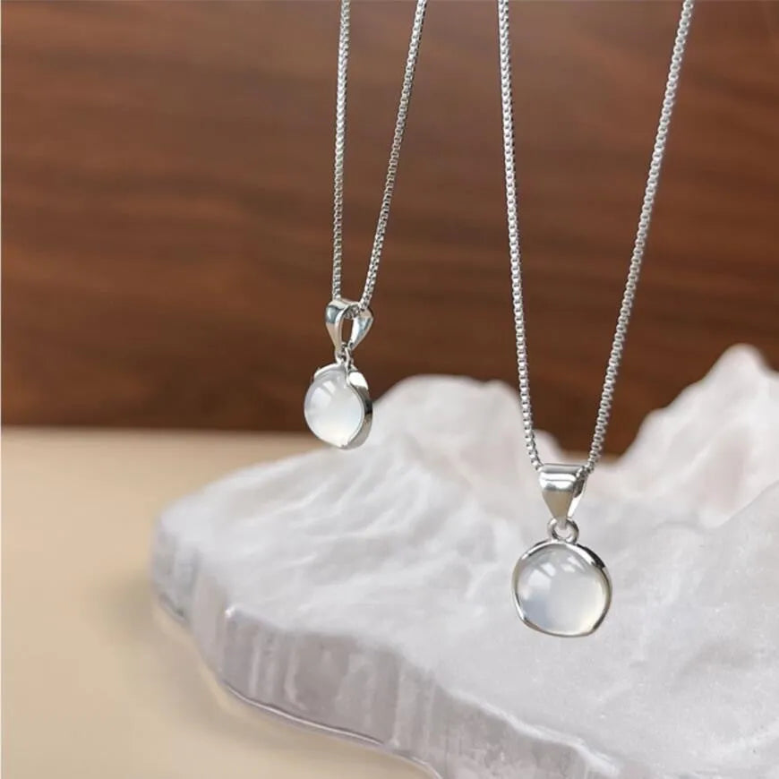Korean-style oval pendant necklace with geometric eight-point star charm on an adjustable box chain.