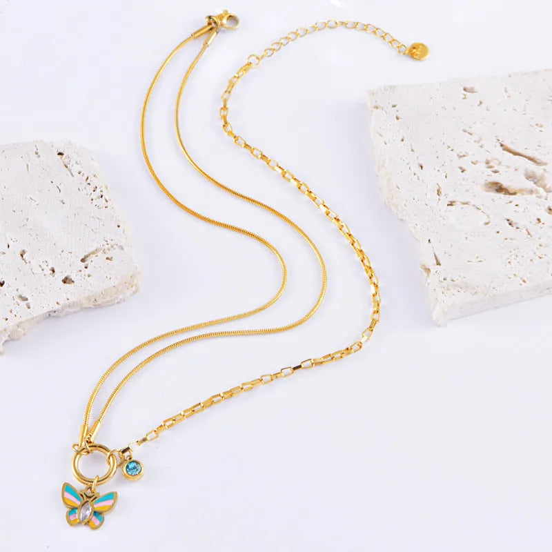 Gold coloured titanium steel necklace and bracelet set with colourful epoxy butterfly pendant