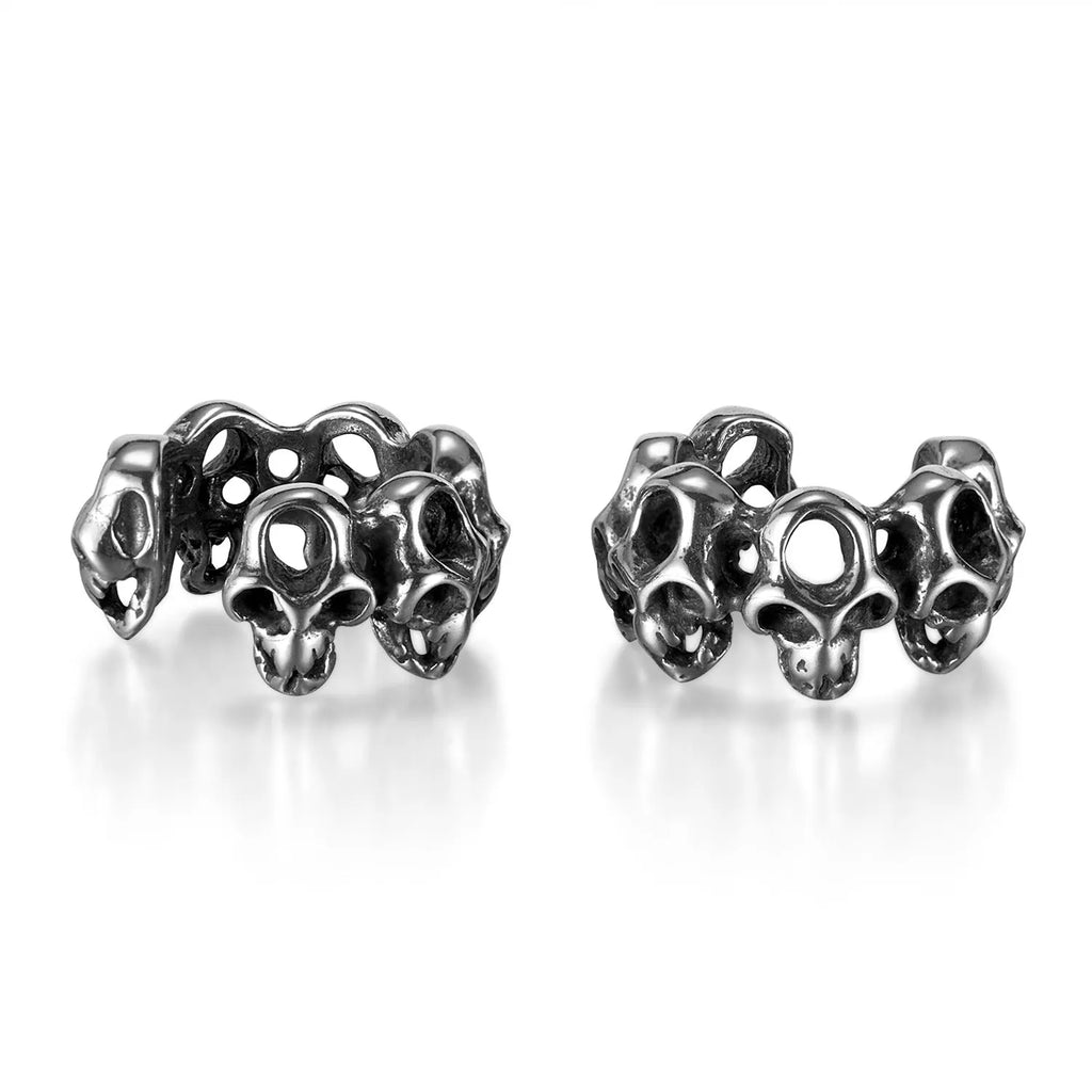 Stainless steel clip-on earrings featuring a hollow geometric skull design with an electroplated finish.