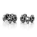 Stainless steel clip-on earrings featuring a hollow geometric skull design with an electroplated finish.
