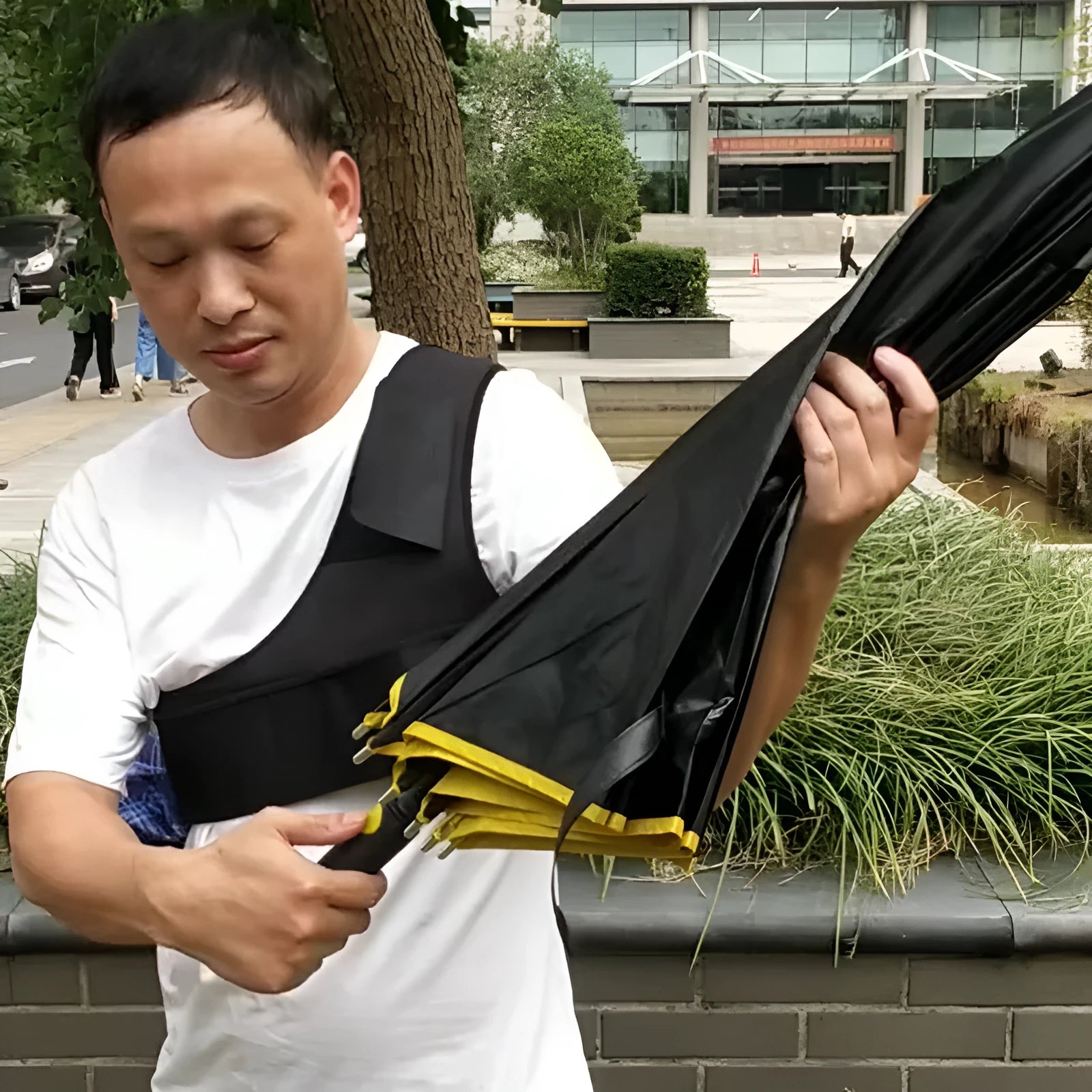 Portable umbrella holder with shoulder strap in diving cloth, shown in black colour