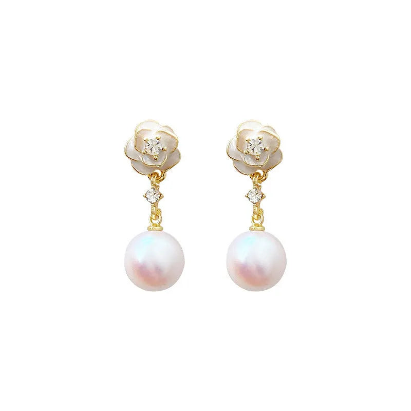 Close-up of Camellia Pearl Flower Stud Earrings for women, showing detailed floral alloy design with faux pearl centre.