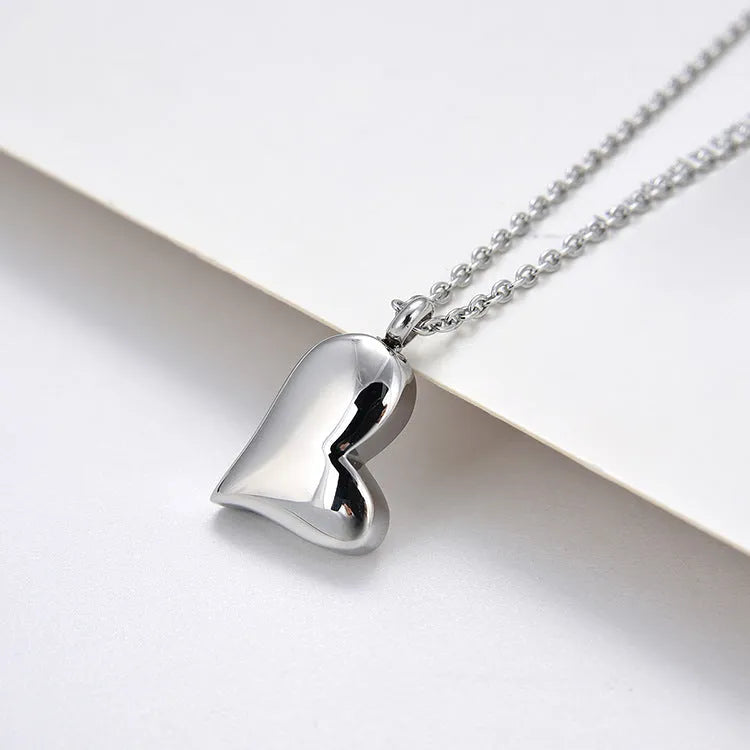 Silver curved peach heart pendant on stainless steel necklace chain with extension