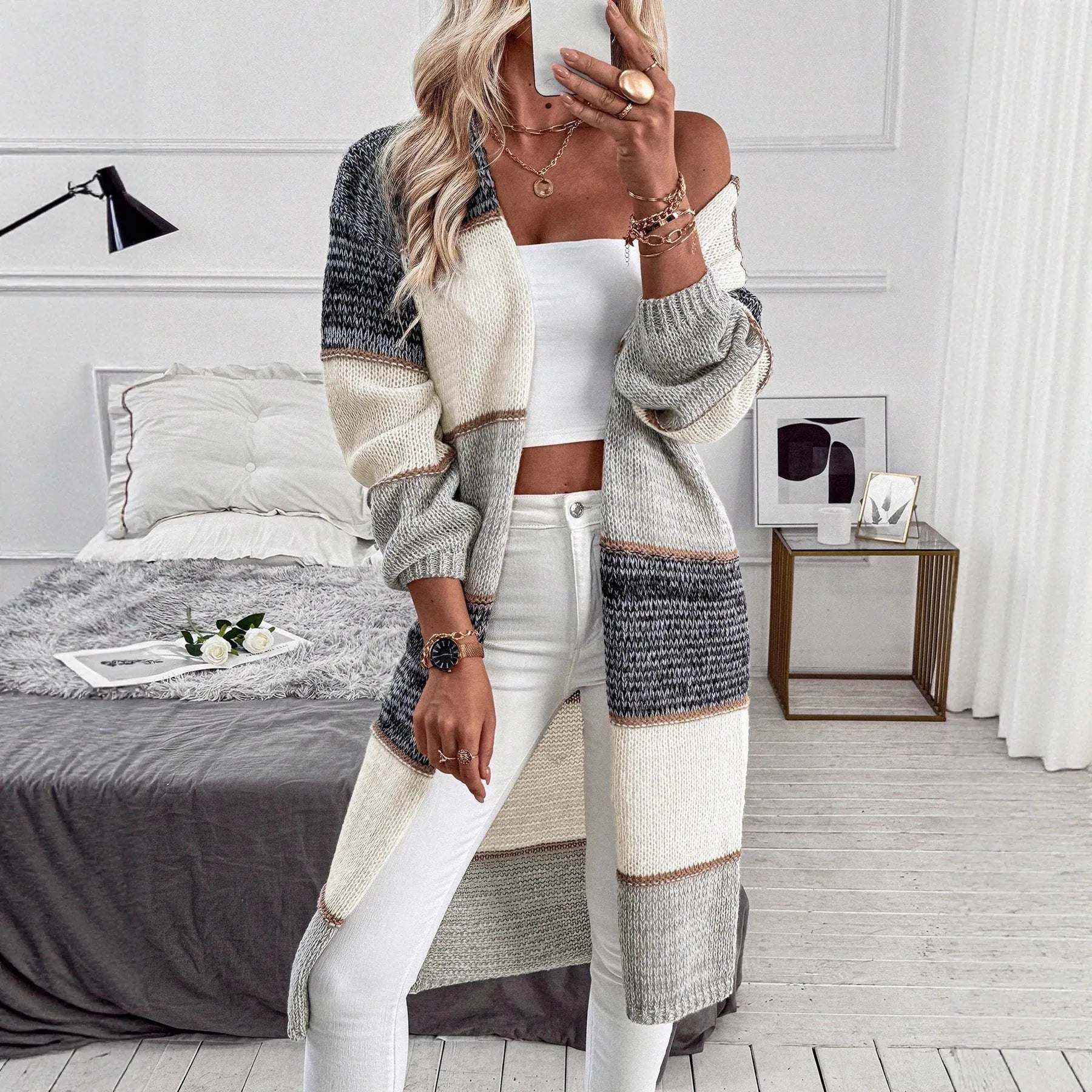 Grey knitted long cardigan with loose fit and long sleeves on a woman
