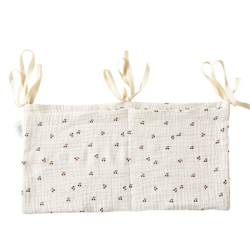 Cotton double layer baby bedside buggy bag in camel colour with tie straps attached to a pram handle