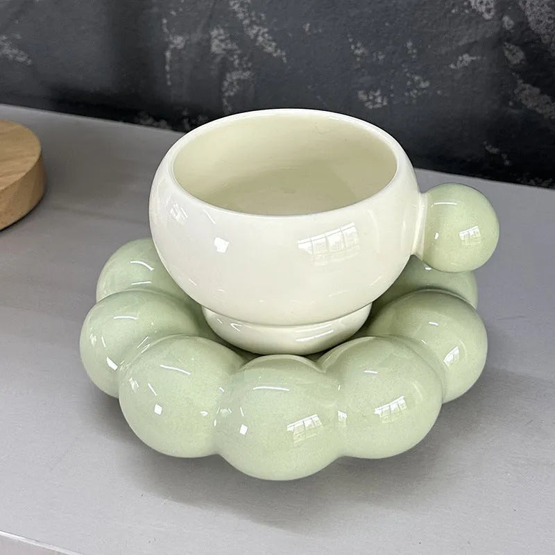 Ceramic coffee cup and saucer set in a simple solid colour, showing the 250ml cup resting on its matching dish.