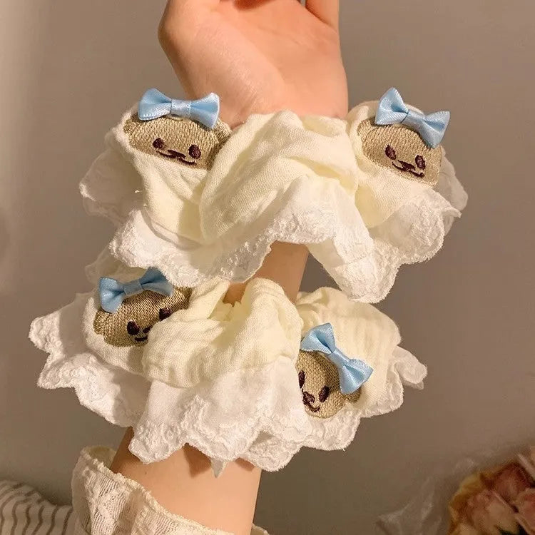 Blue bear bow and lace cloth hair ring with large intestine design on dark background