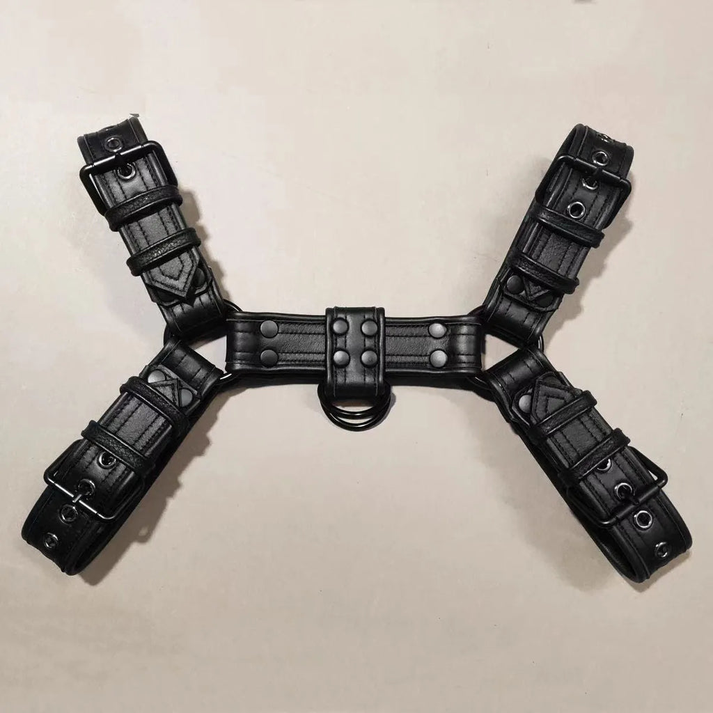 Black leather chest bondage strap with metal buckle and rivet details for adult costume use.