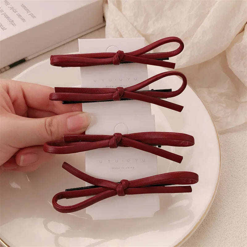 Wine red leather bow hair barrette showing handmade bow design detail