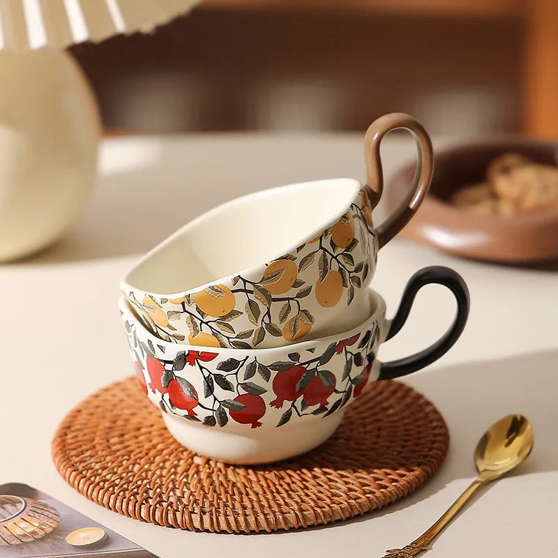 Antique ceramic coffee cup and saucer set in black or orange with medieval fruit design