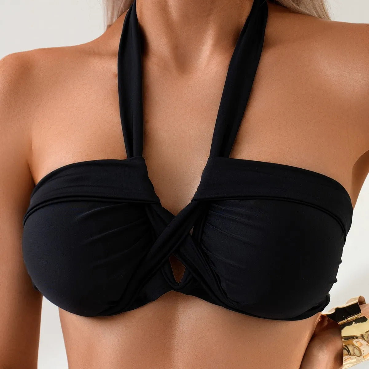 Black backless brief style women's bikini swimsuit on a mannequin.